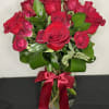 A stunning vase arrangement of rich red roses and red spray roses