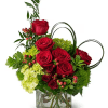 This arrangement features striking red roses, vibrant mini green hydrangeas, elegant tricolor