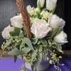 Embrace the serene beauty of this exquisite arrangement, featuring creamy white Roses