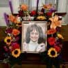 1/2 circle of vibrant flowers surrounding a picture 
