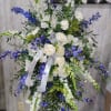 Gorgeous standing sympathy spray full of a variety of blooms and greenery.
