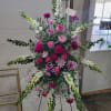 Gorgeous standing sympathy spray full of a variety of blooms and greenery.
