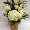 This clean, white and green arrangement comes complete with white hydrangeas, white