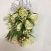 Add some elegance to your special occasion with a white corsage of