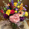 This lovely and wild arrangement features a multitude of color and lovely
