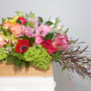 A dazzling display of hot-pink Roses, plum-purple Lisianthus, Proteas, Kermit-green Orchids amid