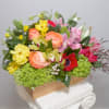 A dazzling display of hot-pink Roses, plum-purple Lisianthus, Proteas, Kermit-green Orchids amid