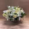 Dressed in creams and whites, this floral display is simply perfect for