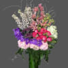 nice mix of exotic flowers in a tall cylinder vase with white