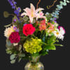 nice mixed flowers in a large vase. curly willow, red roses, green