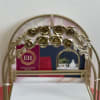 This elegant floral organizer features a sturdy gold metal frame adorned with
