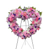 This exquisite floral arrangement features a vibrant open heart design, artfully crafted