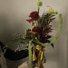 A bold and dramatic composition, The Burmese Cat bouquet blends deep crimson