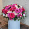 Vibrant floral arrangement, beautifully displayed in a white hatbox. This stunning mix