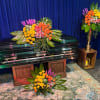 Roses, lilies, and more come together for a blushing pink half casket