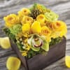This yellow arrangement features a rose, pincushion protea, an architectural shape and