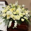 White roses, white carnations, white hydrangeas, stock and greenery.
