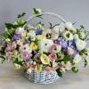This basket is filled with variety of pastel roses and ranunculus and