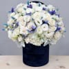 Enjoy this arrangement all year long with seasonal blues, white and greens