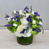 This arrangement features seasonal hydrangeas along with white and blue flowers.

