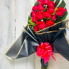 18 Red Roses covered with monstera leaf and a touch of solidago