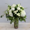 This tall elegant arrangement is made with flowing eucalyptus and all white
