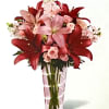 Hand-arranged to perfection within a pink glass vase, this pink lilies arrangement