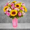 Our bright flower arrangement brings all the happiness of a sunshine-filled day.