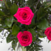 Beautiful and bright hot pink/magenta roses expertly arranged with beautiful greenery and