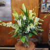 Eucalyptus greenery and white roses are the accompaniment to showcase white Oriental
