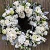 Beautiful white wreath, which includes some gerber daisies, white roses, hydrangea, and