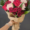 A beautiful wrapped arrangement Of six red roses, six fragrant garden pink
