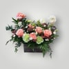 his floral arrangement is a rectangular, garden-inspired display featuring a mix of