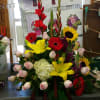 mix arrangement with gladiolas and gerberas sunflower and roses 