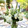 This beautiful arrangement of white flowers is a wonderful choice for any