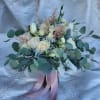 The palette of white, ivory, and blush blooms creates a timeless and