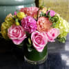 The fun and lively arrangement features beautiful pink Roses, fragrant Hyacinth, lush