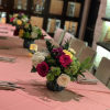 A festive blend of mixed colored, roses, hydrangeas, and mum flowers.