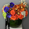 Orange roses, exotic orchids and a selection of other seasonal flowers.