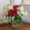 Red Roses, white alstromeria, white stock with arranged with white waxflower for