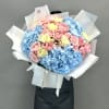 A stunning duet of blue hydrangeas and Juliette garden spray roses, complemented