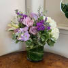 Lavender roses, white hydrangea, white lily, lavender chrysanthemums, and stock arranged low