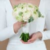 A delicate and elegant bridal bouquet featuring lush ranunculus blooms, perfect for