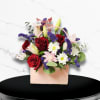 Our unique flower arrangement is nestled within a chic, purse-shaped bag, making
