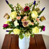 This simple yet vibrant flower arrangement is a delightful assortment of fresh