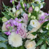 Picture a full and abundant arrangement bursting with lavender and ivory blooms: