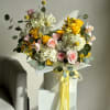 The &quot;Easter Sunny Arrangement&quot; bursts with vibrant colors and cheerful blooms, embodying