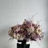 This beautiful arrangement is filled with beige roses, stock and greens to