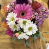 BRIGHT MIXED BLOOMS ARTFULLY DESIGNED IN A LOW CUBE VASE