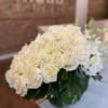 Two dozen white roses, white dendrobium orchids and white hydrangea in our